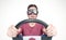 Scared man with open mouth in stylish goggles with steering wheel, car driver concept. Front view