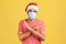 Scared man in santa claus hat with surgical medical mask on face standing crossing hands, showing x sign meaning stop, keep