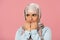 Scared muslim girl in hijab biting nails, isolated on pink