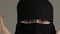 Scared muslim woman in niqab opens hers face