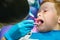 Scared red-haired boy crying at reception at dentist in dental chair