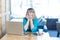 Scared! Side view portrait of emotional nervous young girl with blonde hear in blue blouse are sitting in cafe, working alone and