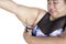 Scared woman cuts her fat upper arm on studio
