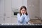 Scared woman pianist in amazement looks at a musical instrument, fear in the eyes of a musician