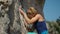 scared woman rock climber climbs on cliff, talking to her climbing partner, asking to be care and attentive. rock
