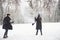 Scarf have flied up. Gorgeous young couple playing and throwing snowballs in winter forest