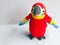 Scarlet Macaw with a band of yellow followed by a band of blue leading to the flight feathers, a cute children toy, red bird with