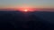 A scarlet sunset behind a high mountain range