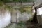 Scarry creepy green moss covered walls of dilapidated room with broken metal industrial ventilation at abandoned military complex