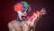 Scary clown with spooky makeup and more candy