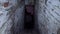 Scary dark entrance and collapsing brick stair to frightening basement or dungeon, barn in village for food stocks. Old blanket