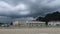 Scary dark storm cloud over government center building with car park spot