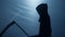 Scary death silhouette in gown holding scythe, terrible Grim Reaper nightmare