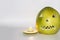 Scary face carved in pomelo fruit with candle in front isolated in gray background