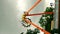 Scary giant metal wheel swing pendulum with people playing with excitement in an amusement park with dark cloudy sky thunder storm
