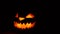 Scary glowing halloween pumpkin face in dark, moving horror halloween decor