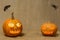 Scary glowing pumpkins faces. Scary Halloween pumpkins isolated on a burlap background.