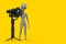 Scary Gray Humanoid Alien Cartoon Character Person Mascot with DSLR or Video Camera Gimbal Stabilization Tripod System. 3d