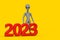 Scary Gray Humanoid Alien Cartoon Character Person Mascot with Red 2023 New Year Sign. 3d Rendering