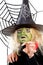 Scary green witch for Halloween with spiderweb