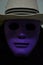 Scary hallow man in violet mask and black coat