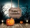 Scary Halloween background with a wooden sign.