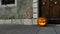 Scary Halloween pumpkin next to a door and wall