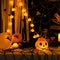 Scary Halloween pumpkins on dark background. Halloween card concept. Spooky glowing faces with candlelight
