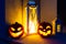 Scary Halloween pumpkins glowing at night as decoration on the front steps