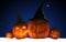 Scary Jack O Lantern halloween pumpkins wearing black witch hat