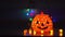 Scary laughing pumpkins and old skulls on the table. Halloween. Witchcraft and magic. Halloween pumpkins glow scary in the night f