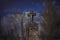 Scary leaning cross tomb stones in a foggy dark winter scene. Old creepy Christian grave on cemetery in Europe. Halloween