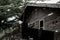 A scary looking wooden house at a park, giving an eerie vibes around it in the midday