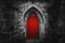 Scary pointy red wooden door in an old and wet stone wall building with cross, skull and bones at both sides. Concept mystery,