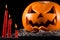 Scary pumpkin, jack lantern, pumpkin halloween, red candles on a black background, halloween theme, pumpkin killer