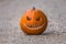 Scary smiling halloween pumpkin with nasty face on ground