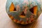 Scary smiling pumpkin halloween lantern on table