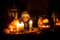 Scary toddler child in halloween costume, playing with carved pumpkins