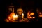 Scary toddler child in halloween costume, playing with carved pumpkins