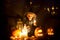 Scary toddler child in halloween costume, playing with carved pumpkins