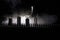 Scary view of zombies at cemetery dead tree, moon, church and spooky cloudy sky with fog, Horror Halloween concept with glowing