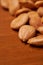 Scattered almond nuts on a brown background. Selective focus