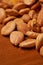 Scattered almond nuts on a brown background. Selective focus