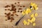 Scattered corn flakes, raisin, spoon on table. Top view