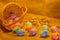 Scattered Easter Eggs, Basket and apricot flowers on sackcloth background