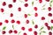 Scattered fresh ripe cherries with tails, leaves on a white background. Cherry background.