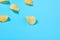 Scattered fried potato chips on blue background