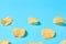 Scattered fried potato chips on blue background