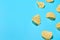 Scattered fried potato chips on blue background