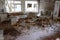 Scattered furniture and toys in an abandoned kindergarten in Pripyat. Mess and rubbish in the room. An abandoned building in the